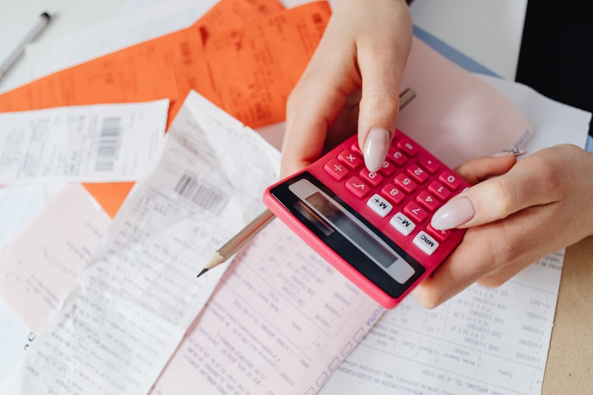 A person working out electricity costs with a calculator